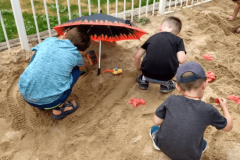 Staying cool playing in the sand and in the shade. 